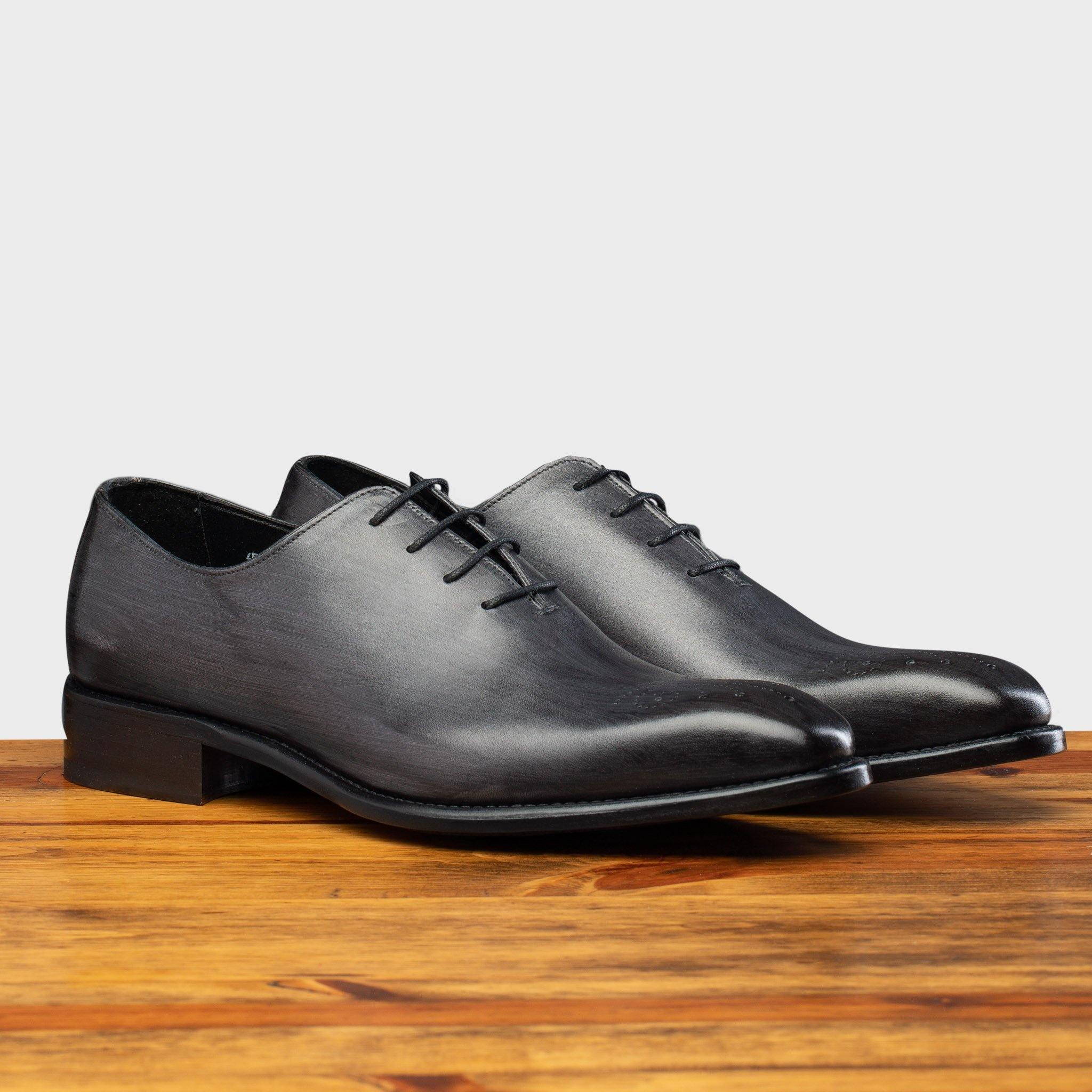 Pair of the 4633 Calzoleria Toscana Grey Cayenne Calf Wholecut Balmoral on top of a wooden table